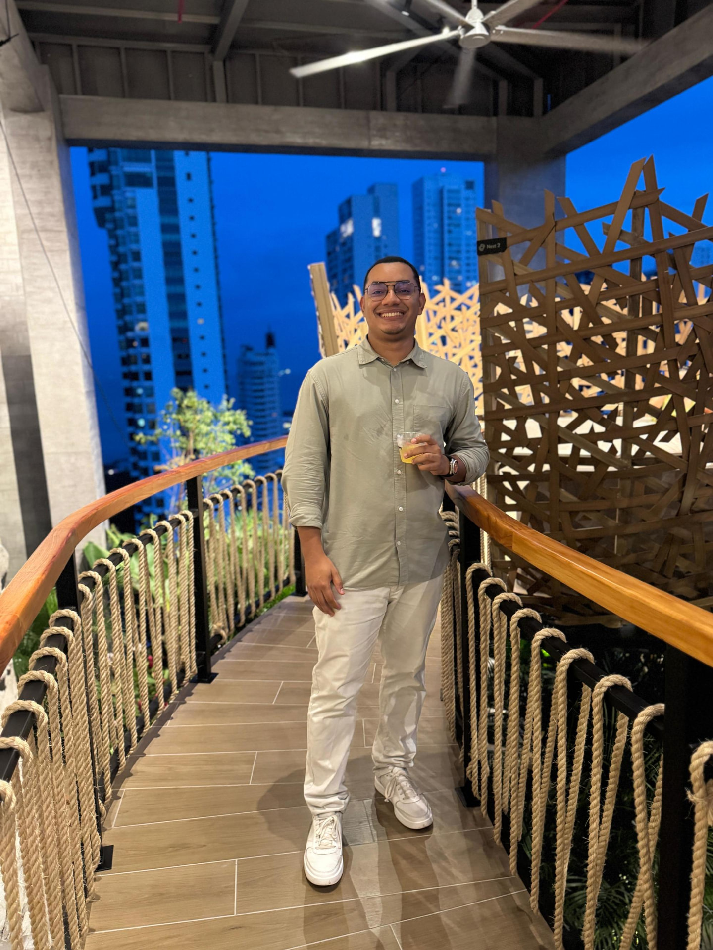 Jorge Faulkner on a rooftop walkway with the Panama City skyline behind him at dusk