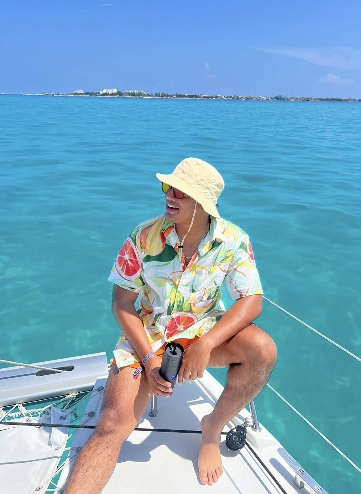 Jorge Faulkner relaxing on a boat in bright turquoise tropical waters
